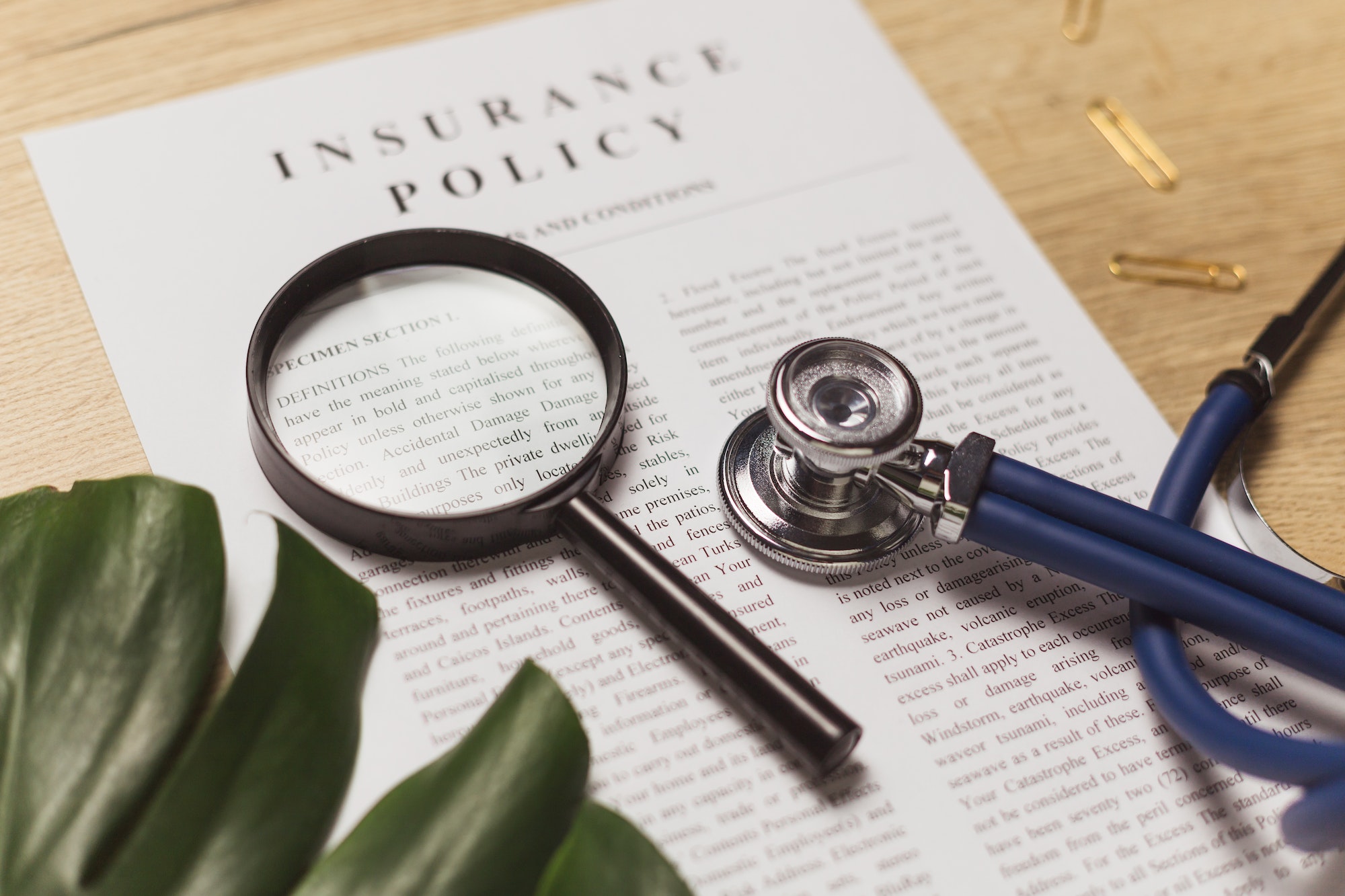 Health insurance. Doctor's stethoscope, magnifier and health insurance contract.